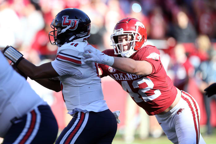 Arkansas Razorbacks linebacker Drew Sanders (42) tackles Liberty Flames quarterback Johnathan Bennett (11) in the second quarter at Donald W. Reynolds Razorback Stadium.